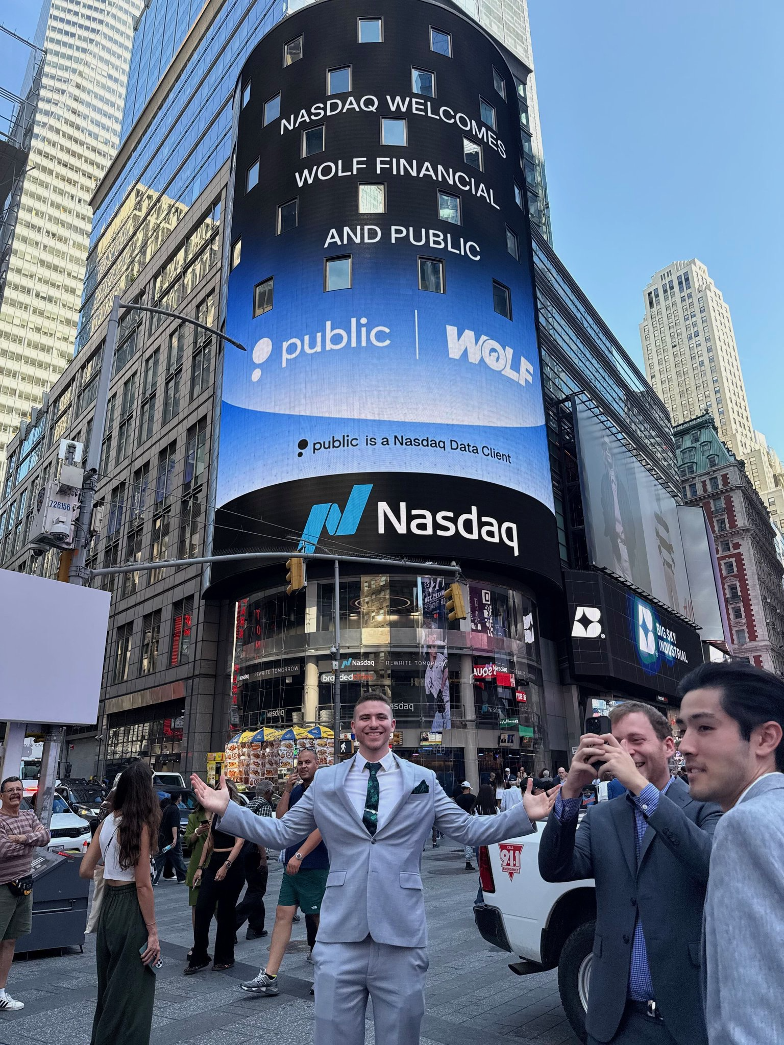Gav Blaxberg in front of Nasdaq Tower displaying WOLF Financial and Public